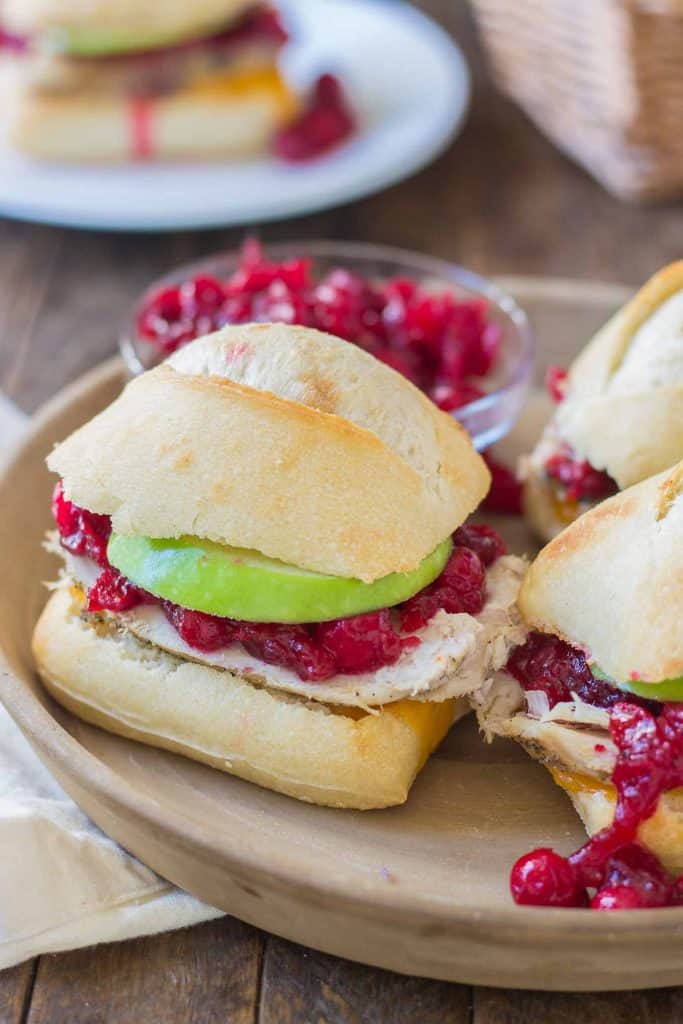 Crispy rolls, smoky turkey and cheese, with tart apples and sweet cranberry sauce come together harmoniously to create these Turkey Cheddar Cran Apple Sliders which are perfect for Thanksgiving leftovers. | Strawberry Blondie Kitchen