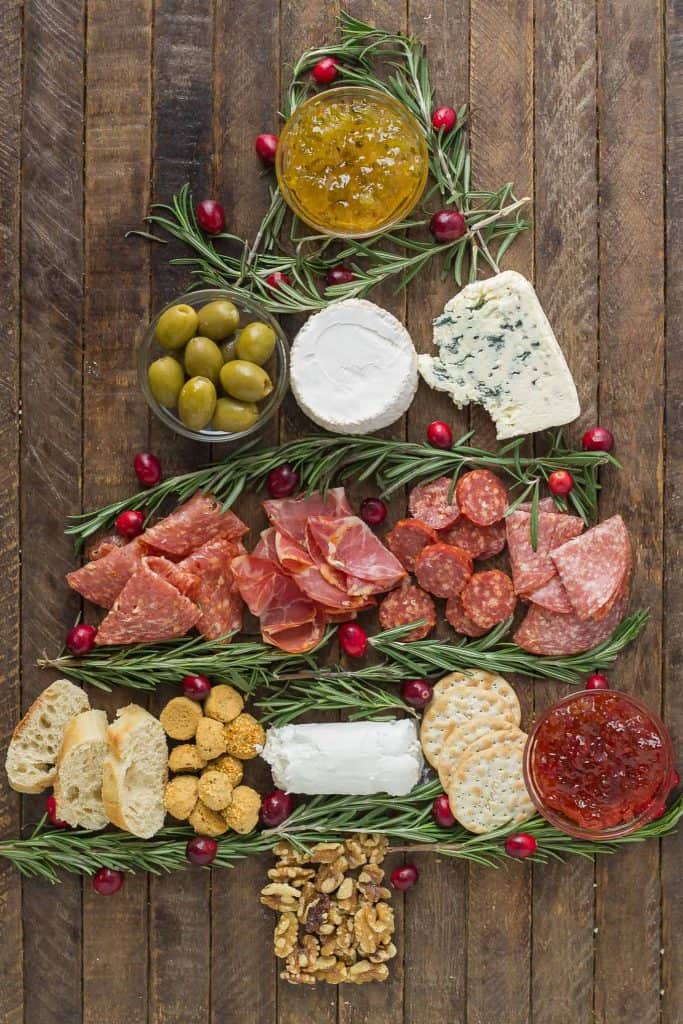 Impress your guests with this Christmas Tree Charcuterie filled with gourmet cheeses, meats and crackers.  The perfect way to start any holiday or cocktail party this season and don't forget the wine! | Strawberry Blondie Kitchen