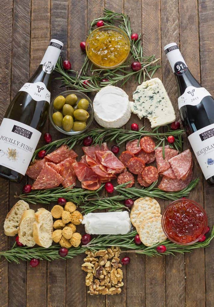 Impress your guests with this Christmas Tree Charcuterie filled with gourmet cheeses, meats and crackers.  The perfect way to start any holiday or cocktail party this season and don't forget the wine! | Strawberry Blondie Kitchen