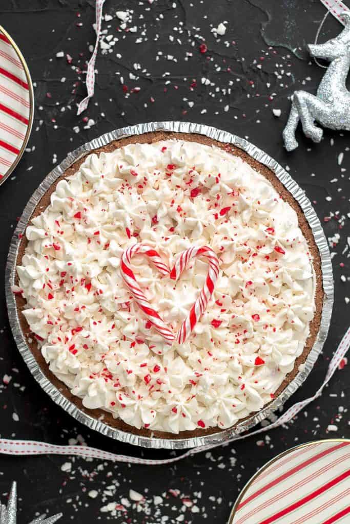 No Bake Candy Cane pie with candy canes on the top forming a heart for a beautiful festive presentation