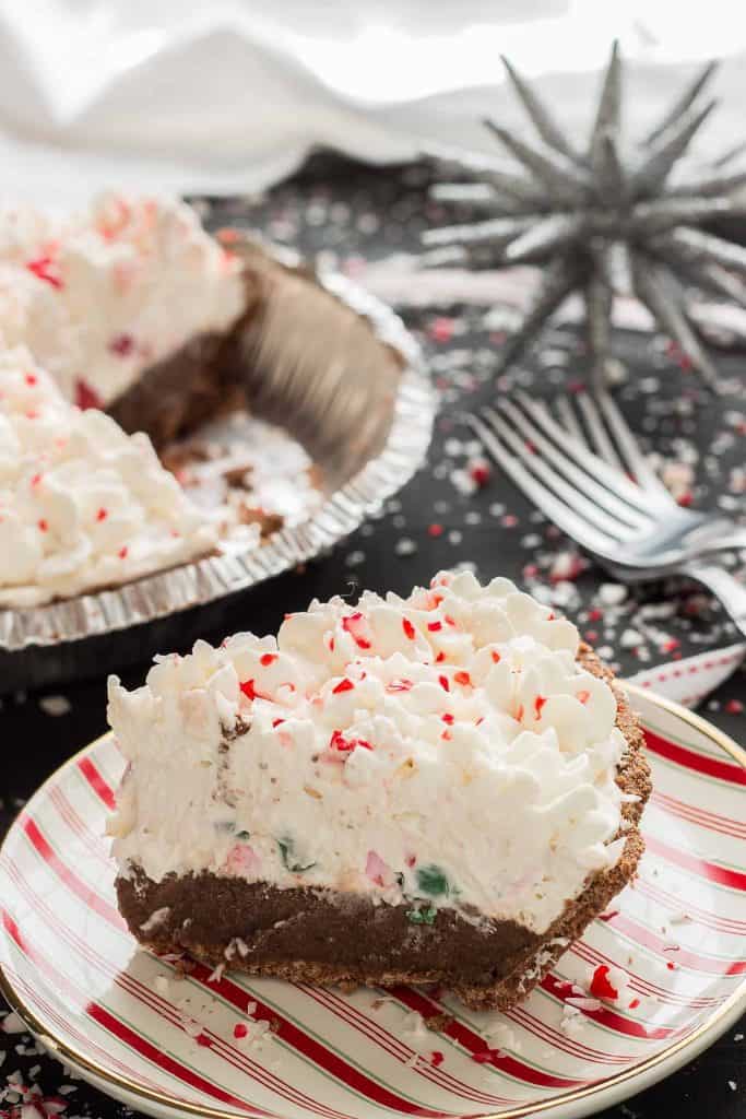 a single piece of no bake candy cane pie on a red and white striped plate