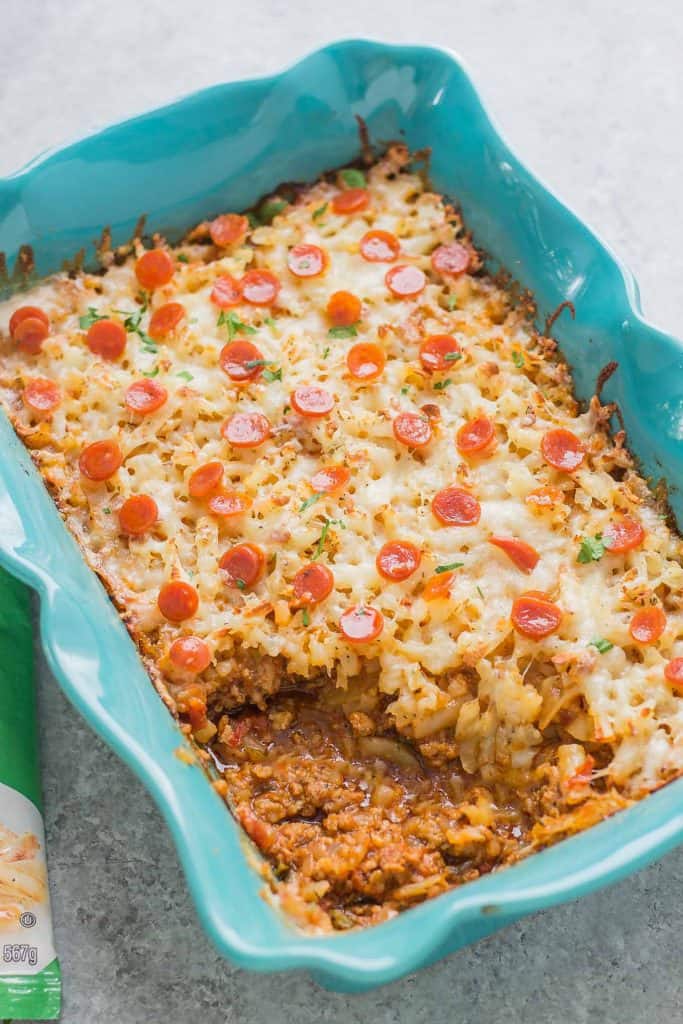 An awesome twist on a classic, this Pizza Shepherd's Pie combines sausage, pepperoni, cheese and hash brown potatoes to give you a hearty casserole worth devouring. | Strawberry Blondie Kitchen