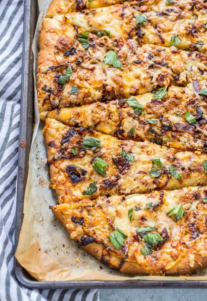This Apple, Bacon and Caramelized Onion Pizza is the epitome of fall in one delicious savory pie.  It's crisp, salty, sweet, and packs a cheesy punch with fontina and sharp white cheddar cheese!