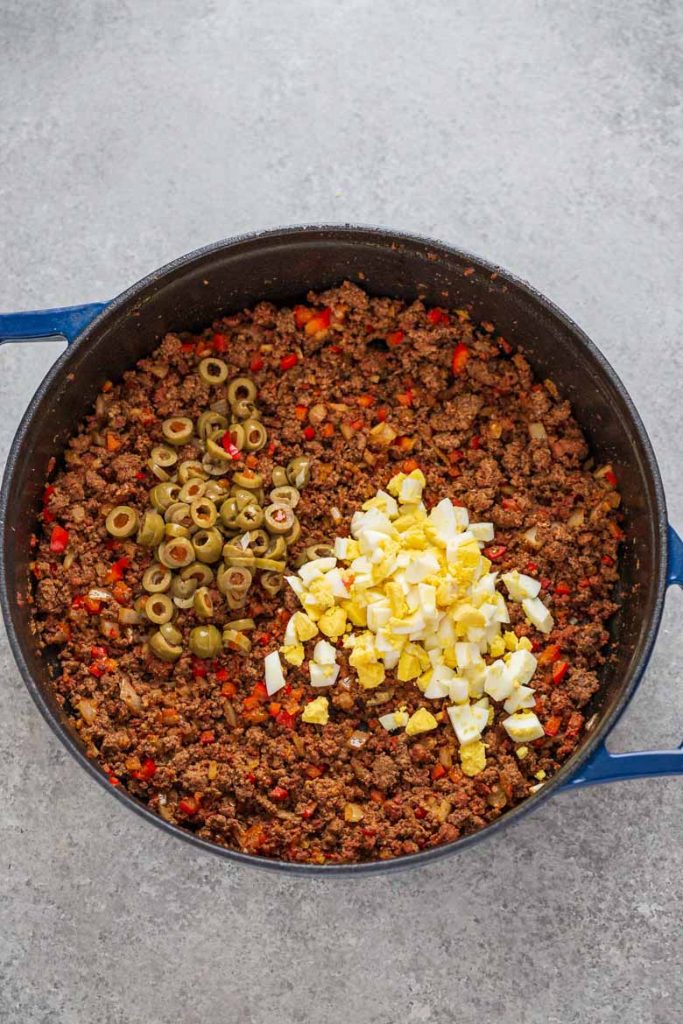 Beef and chorizo cooked with red bell pepper, onion and garlic, green olives and hard boiled eggs for baked beef empanadas