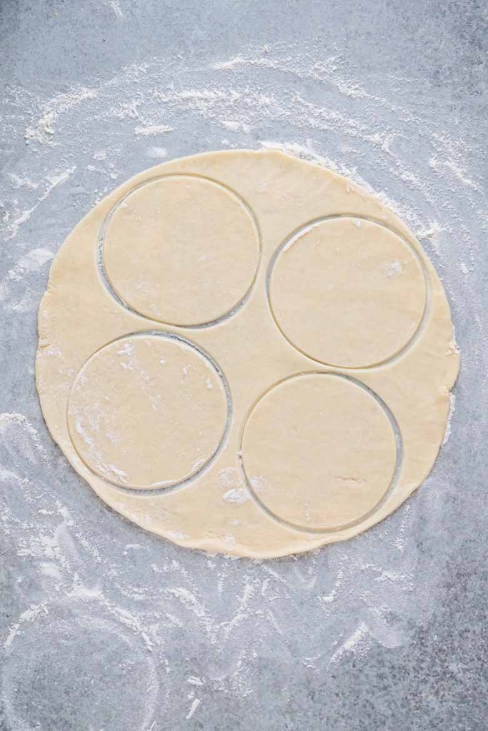 cut circles out of rolled out pie crust to make baked beef empanadas