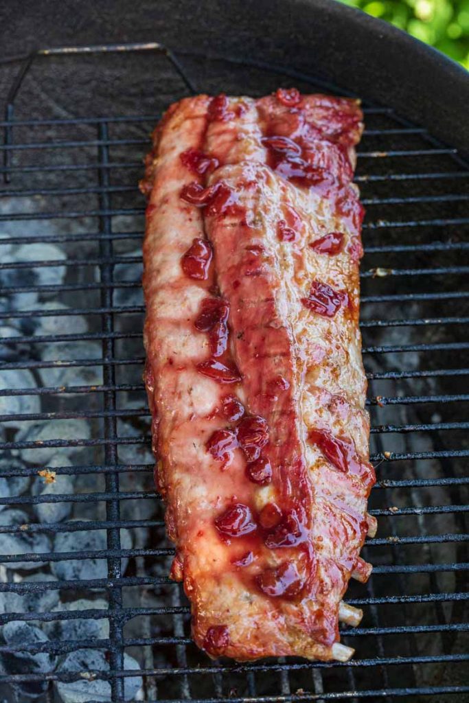 Cherry Pineapple Glazed Ribs on a charcoal grill
