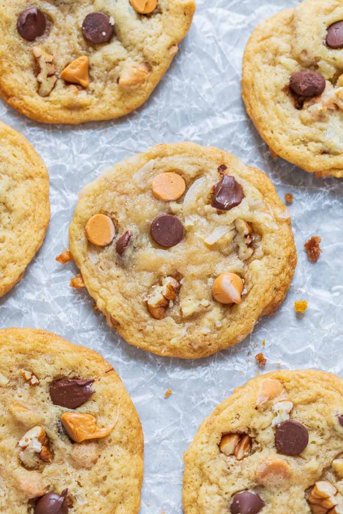 Chewy Seven Layer Cookies are stuffed full of chocolate and butterscotch chips, coconut and pecans.  They're super chewy and soft using a secret ingredient to make them the BEST cookie recipe!