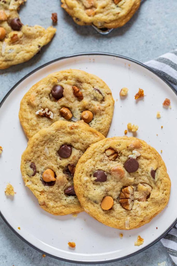 Chewy Seven Layer Cookies are stuffed full of chocolate and butterscotch chips, coconut and pecans.  They're super chewy and soft using a secret ingredient to make them the BEST cookie recipe!