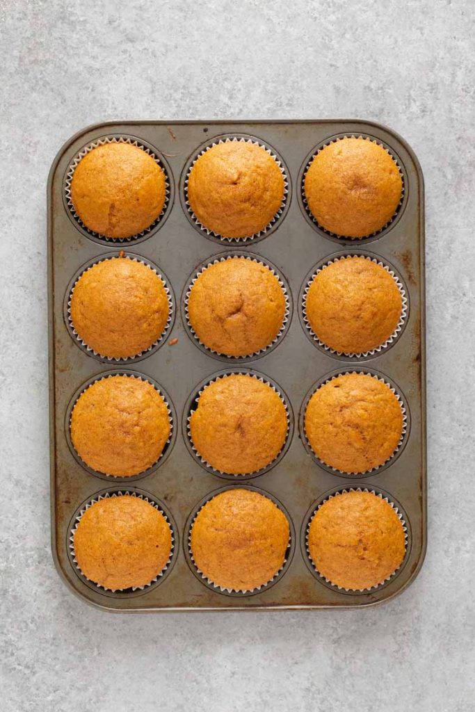 Pumpkin Cupcakes in a muffin tin, fresh out of the oven