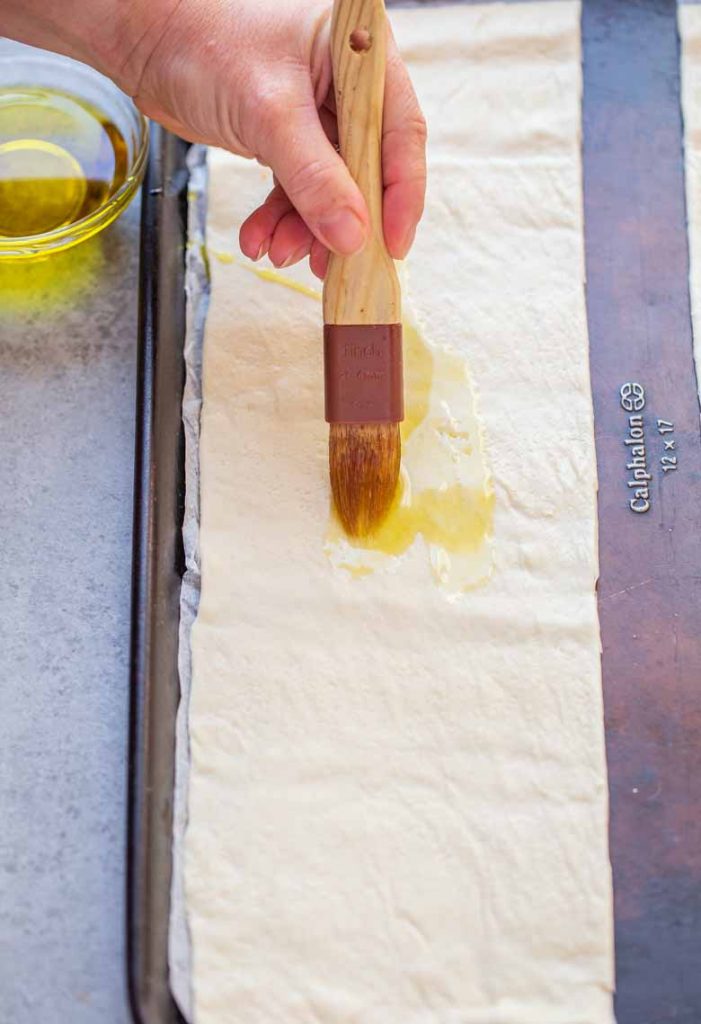 Brush oil onto pizza crust for Easy Margherita Flatbread Recipe