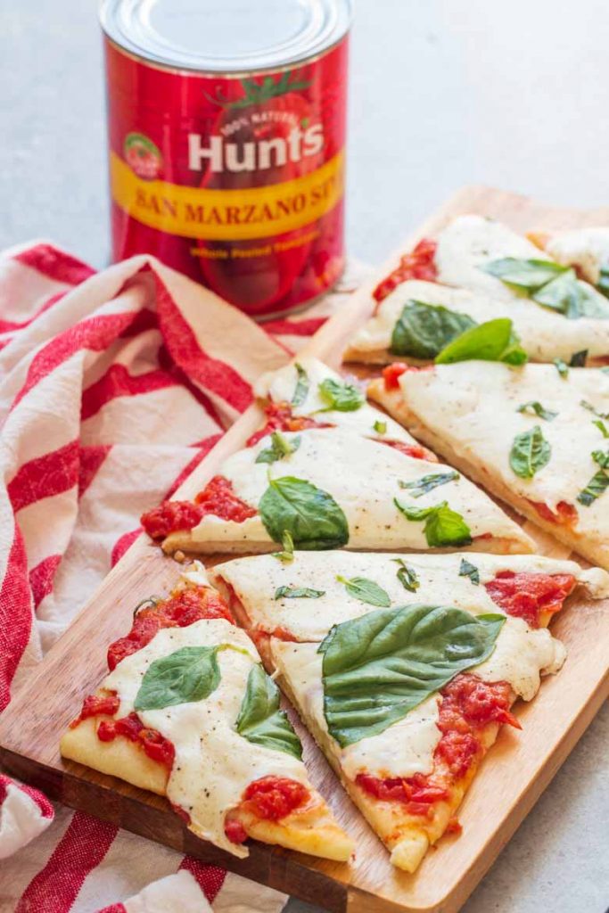 This Easy Margherita Flatbread Recipe is ready in under 20 minutes and thanks to Hunt's San Marzano style tomatoes, it's the freshest flatbread you'll get this side of Italy!