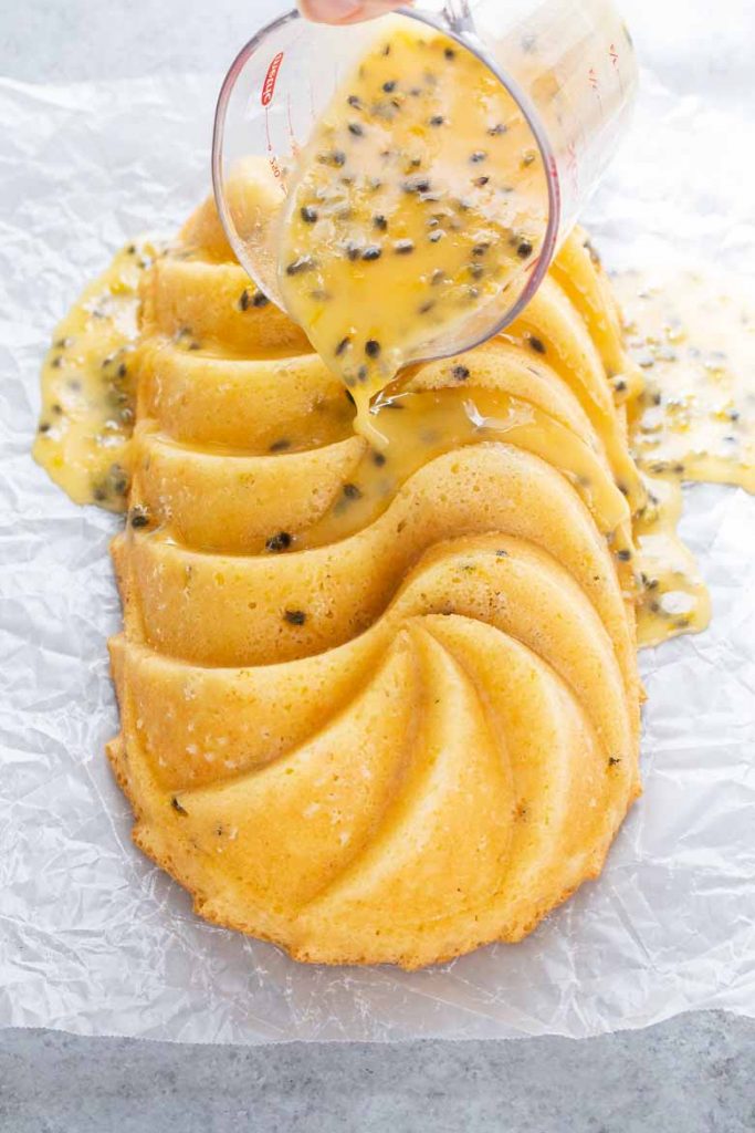 Drizzle passion fruit glaze on top of passion fruit coconut loaf cake