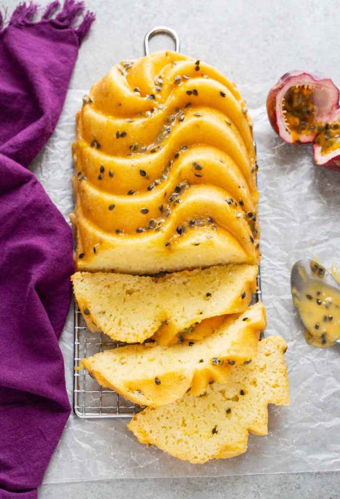 Bursting with sweet and tart tropical flavor, this moist Passion Fruit Coconut Loaf Cake is packed with citrus fruits and drizzled with a passion fruit glaze!