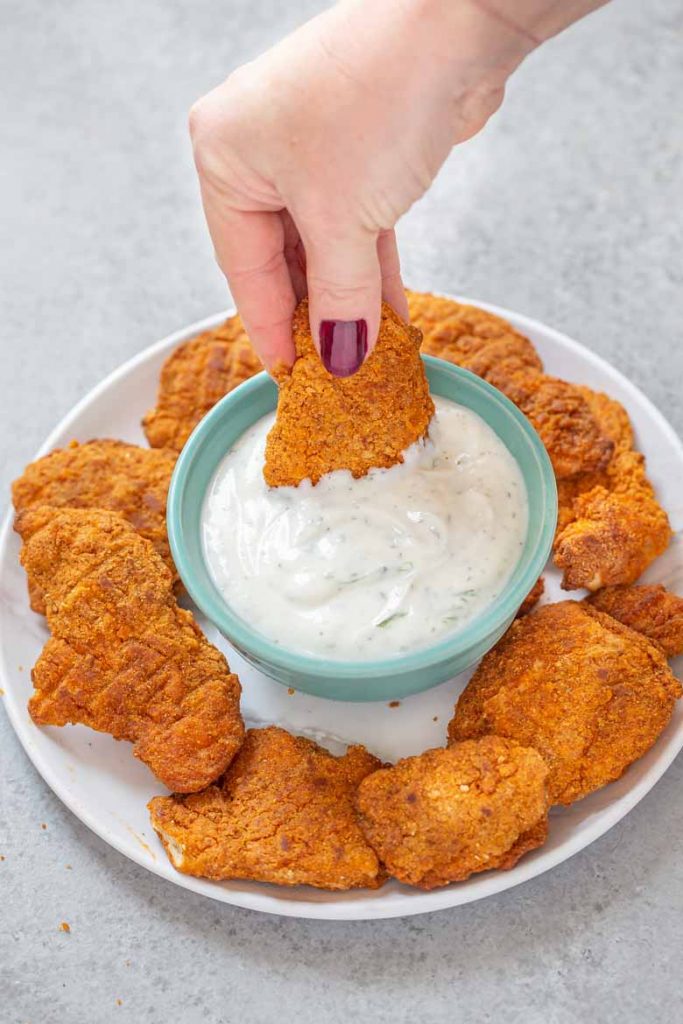 These Baked Chicken Tenders with Healthy Ranch Dipping Sauce are a quick and easy weeknight dinner the whole family will enjoy!