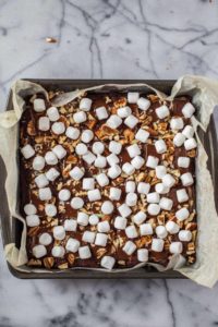 Mocha Mint Mississippi Mud Brownies in pan after baking and topped with pecans and marshmallos