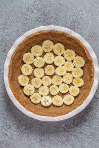 banana slices placed on top of no bake pecan pie crust