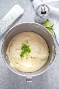 Inside mixing bowl of raspberry Moscow Mule cupcake batter with lime zest