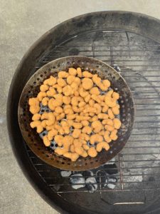 Popcorn shrimp in grill basket on charcoal grill