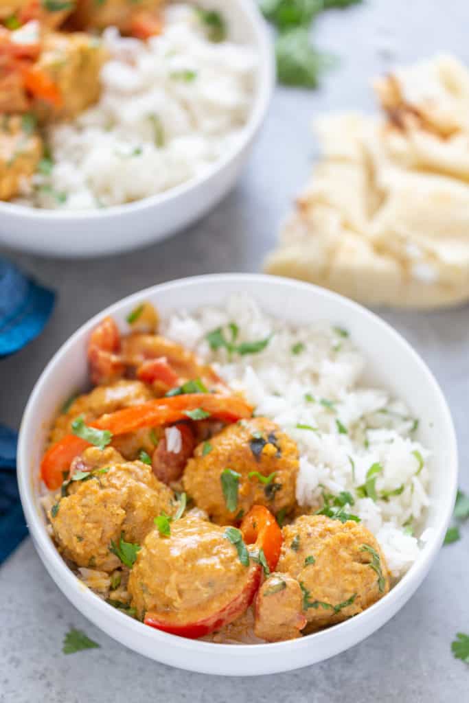 bowl of chicken tikka masala meatballs with jasmine rice