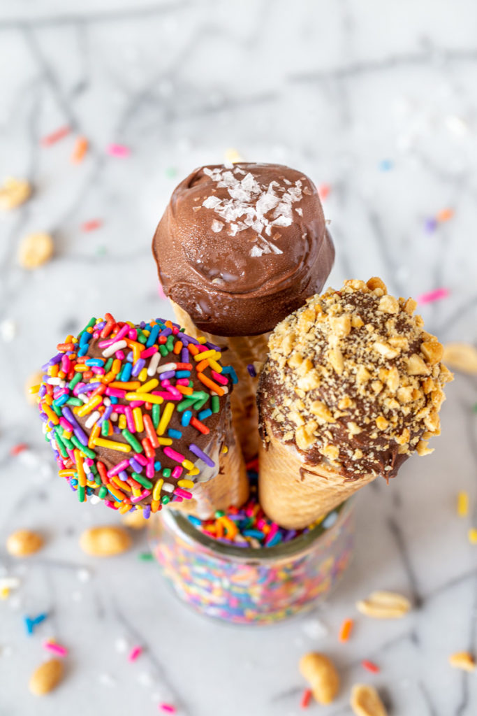 top down photography shot of three homemade drumsticks in a glass jar with sprinkles showing the tops
