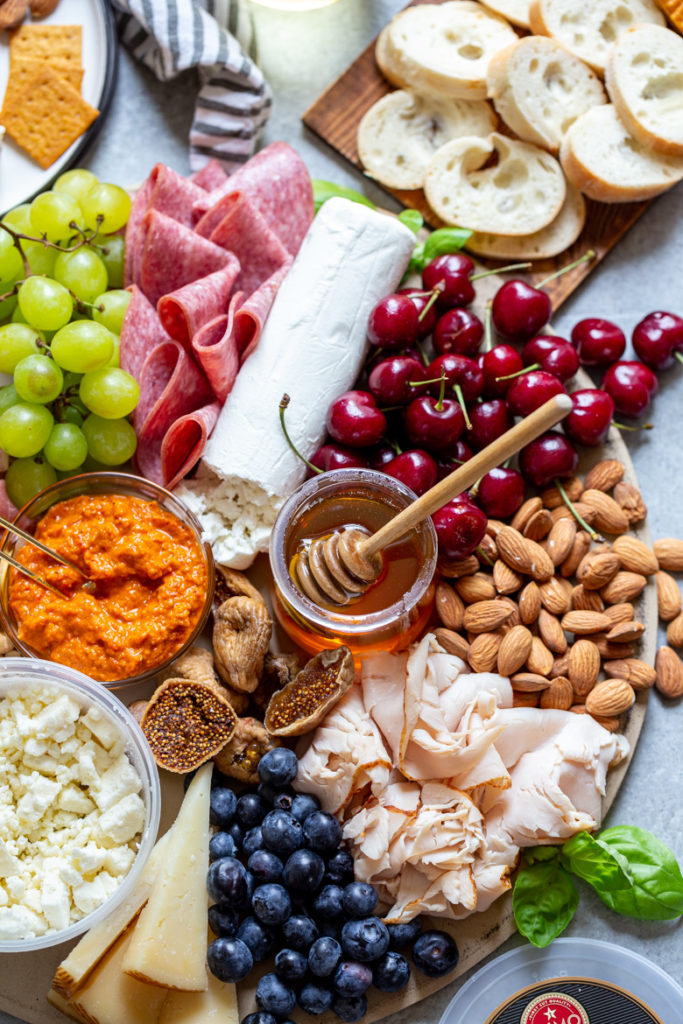 charcuterie board with seasonal produce, nuts, meats and cheeses perfect for entertaining