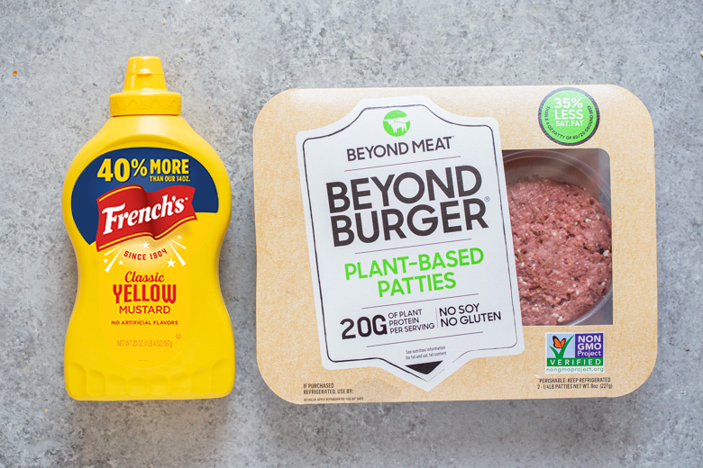 French's Yellow mustard pictured next to a package of Beyond Meat Burger plant based patties