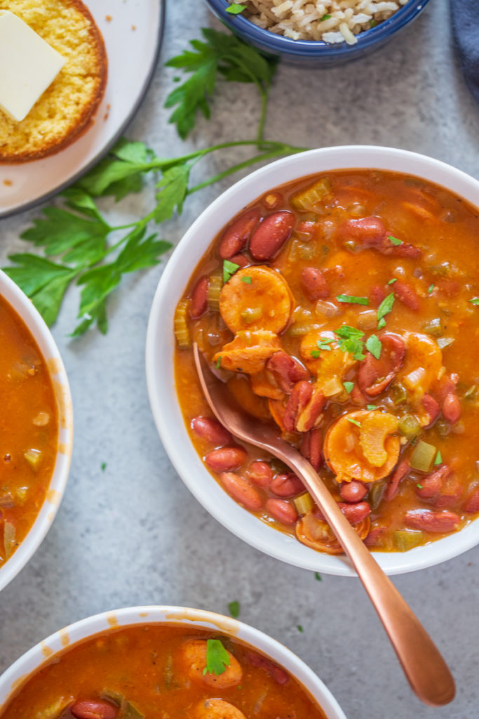 Spoon in a bowl of red beans and rice.