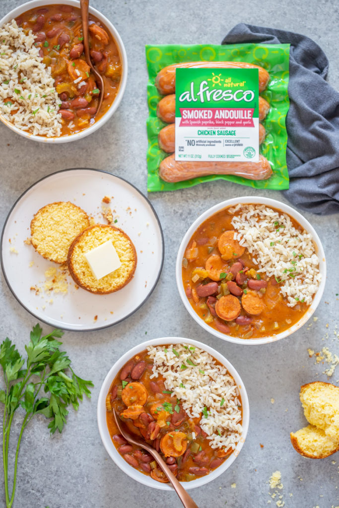 Bowls of red beans and rice, with cornbread and al fresco smoked andouille chicken sausage