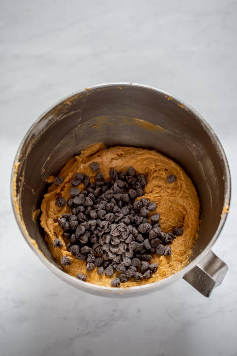 Pumpkin Chocolate Chip Muffin batter in a bowl with chocolate chips
