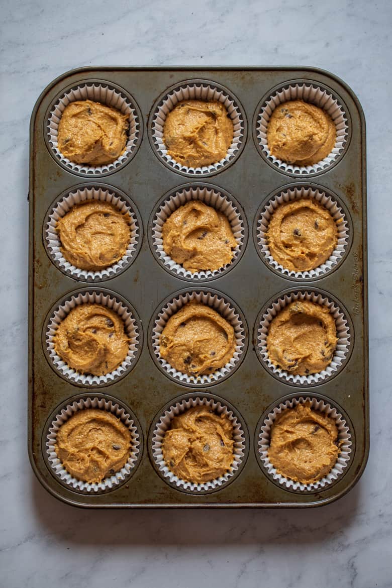 Filled muffin tin with Pumpkin Chocolate Chip Muffins