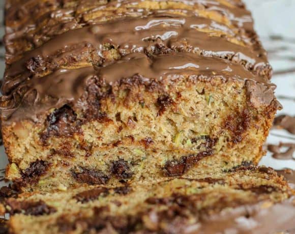 Deliciously moist, chocolaty and flavorful from warm spices such as cinnamon and nutmeg and finally drizzled with more chocolate, this Chocolate Chunk Zucchini Bread will have even the pickiest of eaters going back for a second slice! | Strawberry Blondie Kitchen