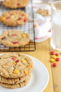 Monster cookies taken up a notch with the flavors of Autumn are both delicious and festive. Peanut butter mixed with pumpkin pie spice, white chocolate and pumpkin spice flavored chips and fall colored m & m's make these autumn monster cookies the perfect treat to serve all season long! | Strawberry Blondie Kitchen