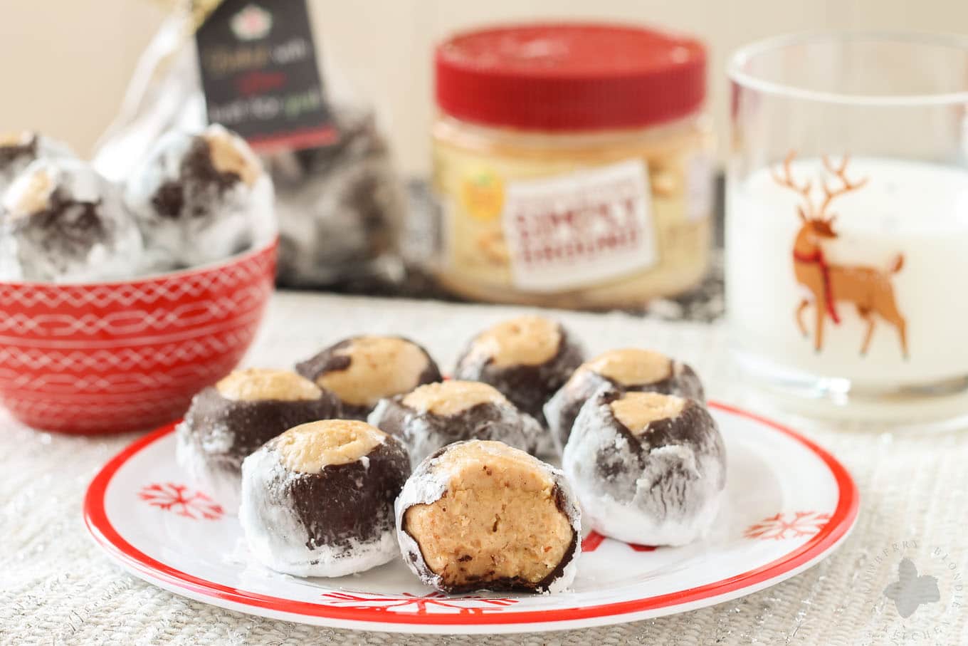 Creamy with a little bit of crunch, Peter Pan® Simply Ground Peanut Butter works beautifully in these Puppy Chow Truffles. Peanut butter balls dipped in chocolate and rolled in powdered sugar are the perfect treat to pass out to all your friends, family and coworkers this holiday season. Bonus-free printable holiday cookie gift tag! No excuses! | Strawberry Blondie Kitchen