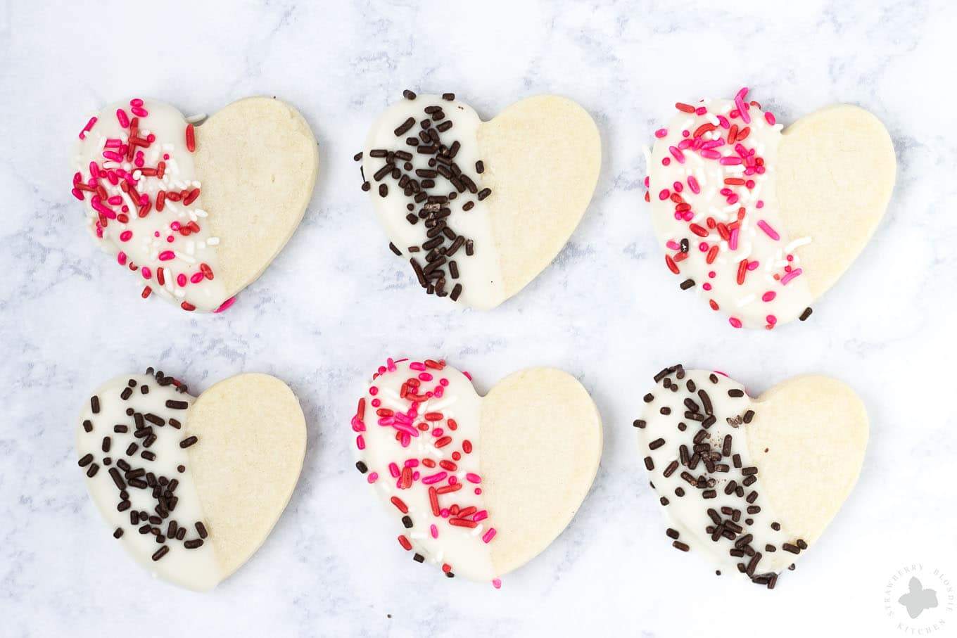 Surprise and delight your Valentine this season with these White Chocolate Cranberry Shortbread Heart Cookies. Nothing says I love you more than fresh home baked cookies shaped like hearts, dipped in white chocolate and covered in sprinkles!