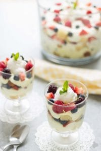 Celebrate the bountiful berries of the season with this Lemon Berry Trifle. Strawberries, blueberries, raspberries and blackberries are layered between tart lemon pudding, whipped cream and studded with delicious pound cake. The perfect summer dessert for all your backyard parties! | Strawberry Blondie Kitchen