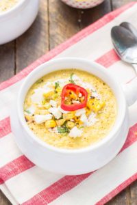 Combine all the flavors you love of Mexican Street Corn and blend them into a delicious summer soup. Sweet corn, lime, chili powder and cheese meld together beautifully to make this luscious and creamy Mexican Street Corn Chowder. | Strawberry Blondie Kitchen