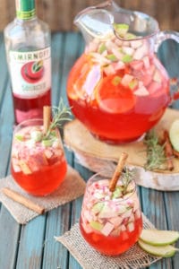 A delicious blend of cranberries, apples, cinnamon, rosemary and seasonal fruits make this Cranberry Apple Rosemary Sangria the go to cocktail of Autumn. | Strawberry Blondie Kitchen