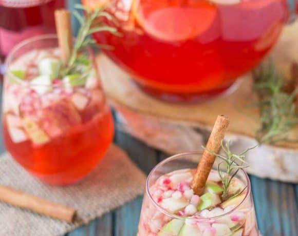 A delicious blend of cranberries, apples, cinnamon, rosemary and seasonal fruits make this Cranberry Apple Rosemary Sangria the go to cocktail of Autumn. | Strawberry Blondie Kitchen