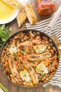 One Pan Tuscan Italian Sausages is a delicious savory dish packed with the big flavors featuring Bertolli pasta sauce cannellini beans, mushrooms, artichokes and nutty farro. Bring the flavors of Tuscany right into your kitchen! | Strawberry Blondie Kitchen