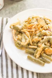 Sharp white cheddar cheese elevates this Slow Cooker White Cheddar Green Bean Casserole to make it the star side dish of your holiday table! | Strawberry Blondie Kitchen