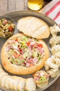 All the classic favorites of an Italian deli sandwich, Meats, cheese, peppers, lettuce and dressing all piled high on top of a baguette make this Chicago Style Hoagie Dip a new game day favorite! | Strawberry Blondie Kitchen