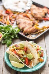 Bursting with flavor and cooked all on ONE pan, these easy Sheet Pan Chicken Fajitas are sure to become permanent in your dinner rotation. You'll love the quick cleanup too! | Strawberry Blondie Kitchen