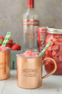 No need to wait for summer to enjoy this delicious and refreshing Strawberry Moscow Mule Float. Made using homemade strawberry vodka and strawberry sorbet, you're sure to love this twist on a classic! | Strawberry Blondie Kitchen