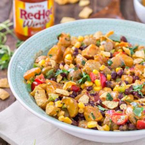 This Mexican Potato Salad is bursting with delicious flavor. Corn, black beans, cherry tomatoes, cilantro and Frank's Redhot Buffalo Wing Sauce make for one amazing side dish for all your summertime gatherings. | Strawberry Blondie Kitchen