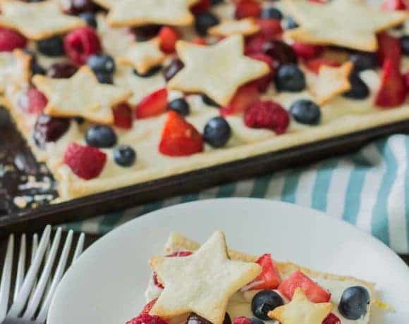 What is more Patriotic than a Star Spangled Berry Sheet Pan Pie?  It's an all American pie loaded with berries, citrus flavors and studded with pie stars.  A delicious addition to all your festive parties this year! | Strawberry Blondie Kitchen