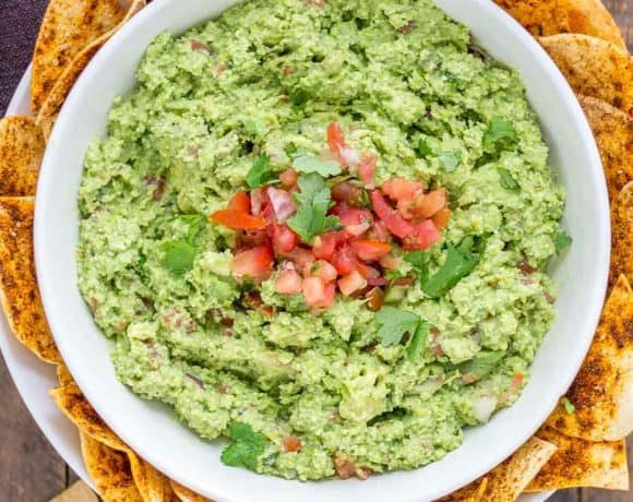 All the flavors you love of guacamole with an added boost of protein and fiber make this Edamame Guacamole super flavorful and a good for you dip. Paired with homemade smoky tortilla chips and you've got one delicious snack. | Strawberry Blondie Kitchen