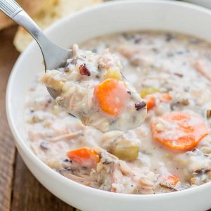 Creamy, delicious and pure comfort food, this healthy Crockpot Chicken and Wild Rice Soup comes together quickly thanks to your slow cooker.  Serve it tonight with some bread for dunking! | Strawberry Blondie Kitchen