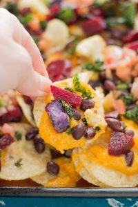 Fall Bounty Sheet Pan Nachos have butternut squash nacho cheese sauce, black beans, kale, roasted cauliflower and beets to give you the ultimate in snacking with all of Fall's delicious produce! | Strawberry Blondie Kitchen