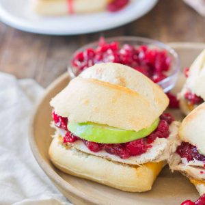 Crispy rolls, smoky turkey and cheese, with tart apples and sweet cranberry sauce come together harmoniously to create these Turkey Cheddar Cran Apple Sliders which are perfect for Thanksgiving leftovers. | Strawberry Blondie Kitchen