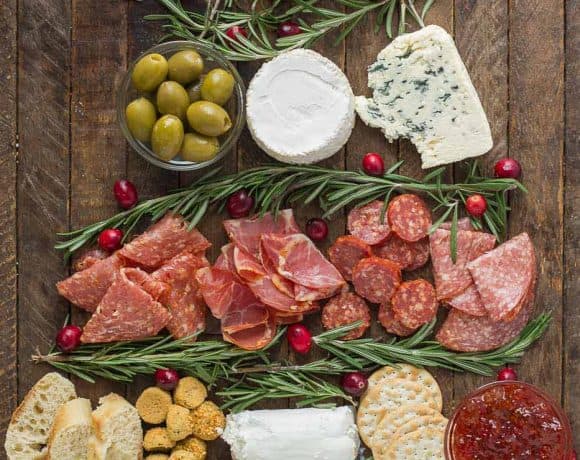 Impress your guests with this Christmas Tree Charcuterie filled with gourmet cheeses, meats and crackers.  The perfect way to start any holiday or cocktail party this season and don't forget the wine! | Strawberry Blondie Kitchen